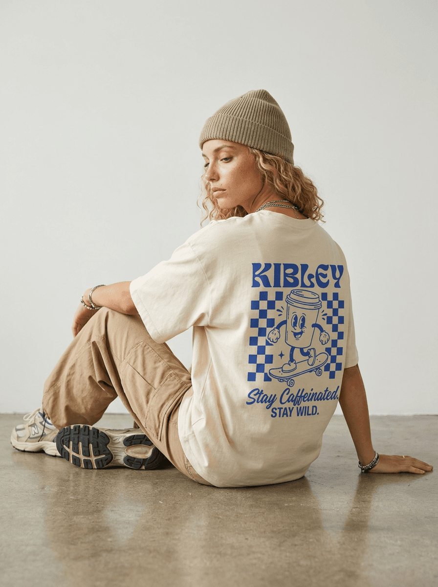 A seated back-view photo featuring the Kibley T-shirt