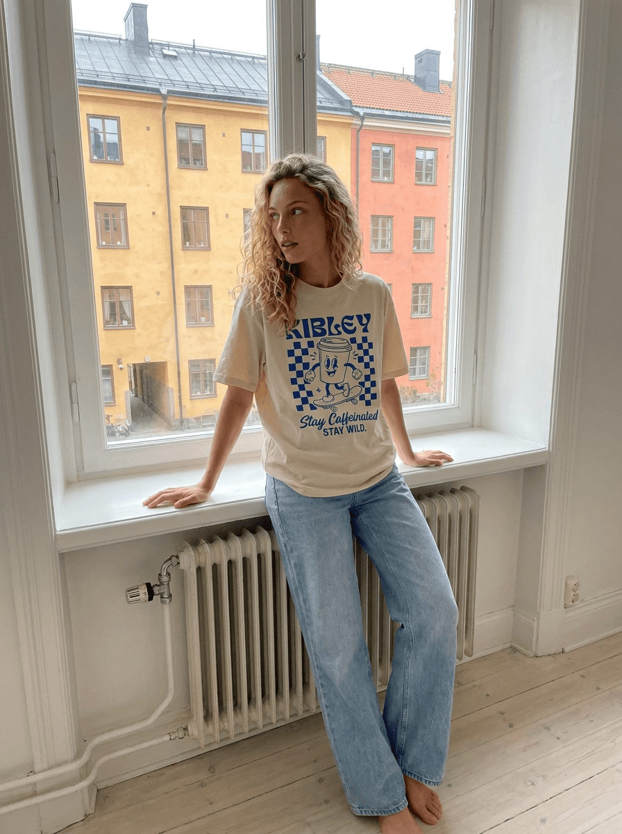 A casual window-side photo featuring the Kibley T-shirt